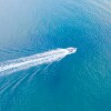 Top view of a white boat with a train sailing to the blue sea