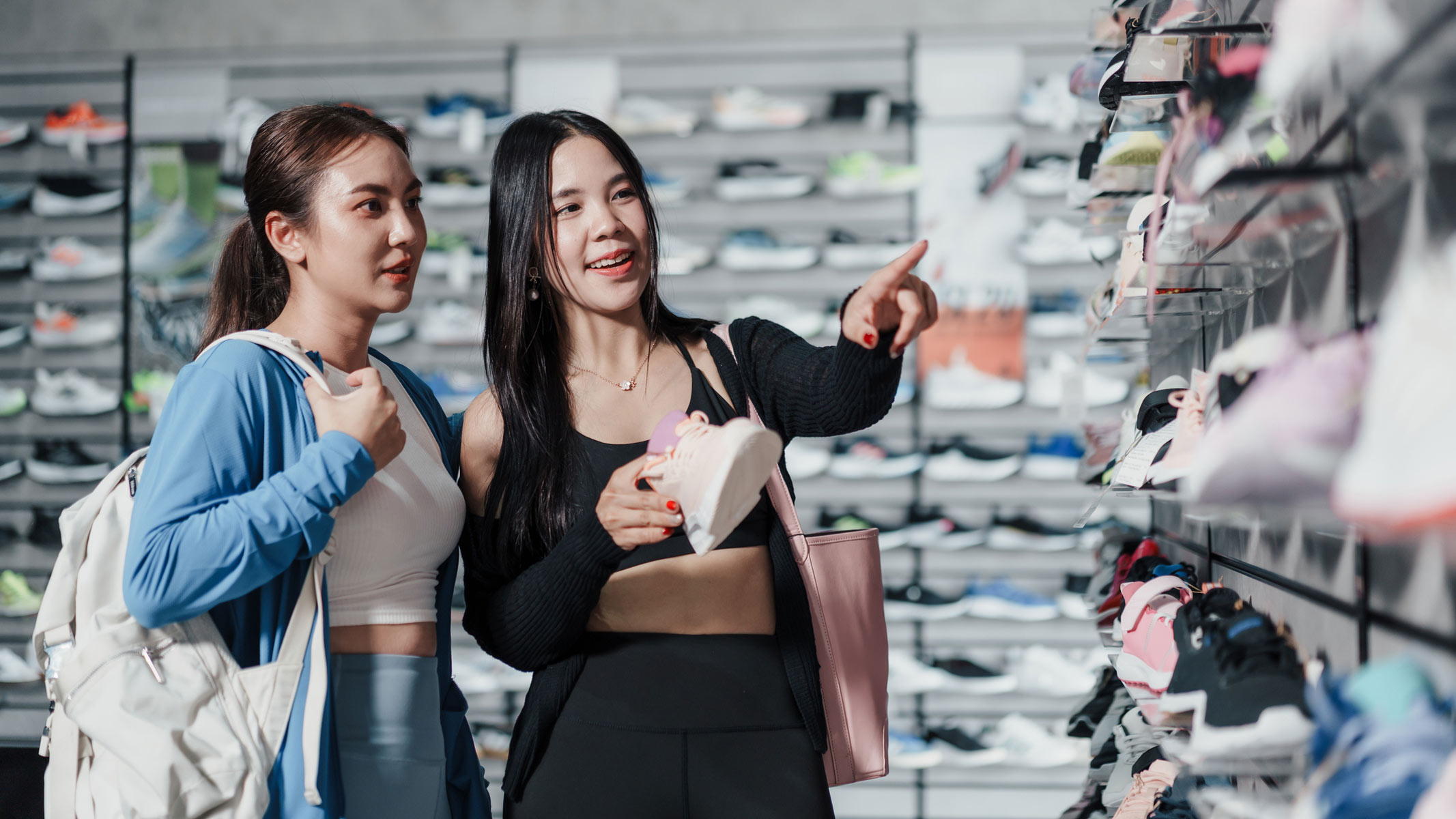 picture of two young women shopping for running shoes in the store