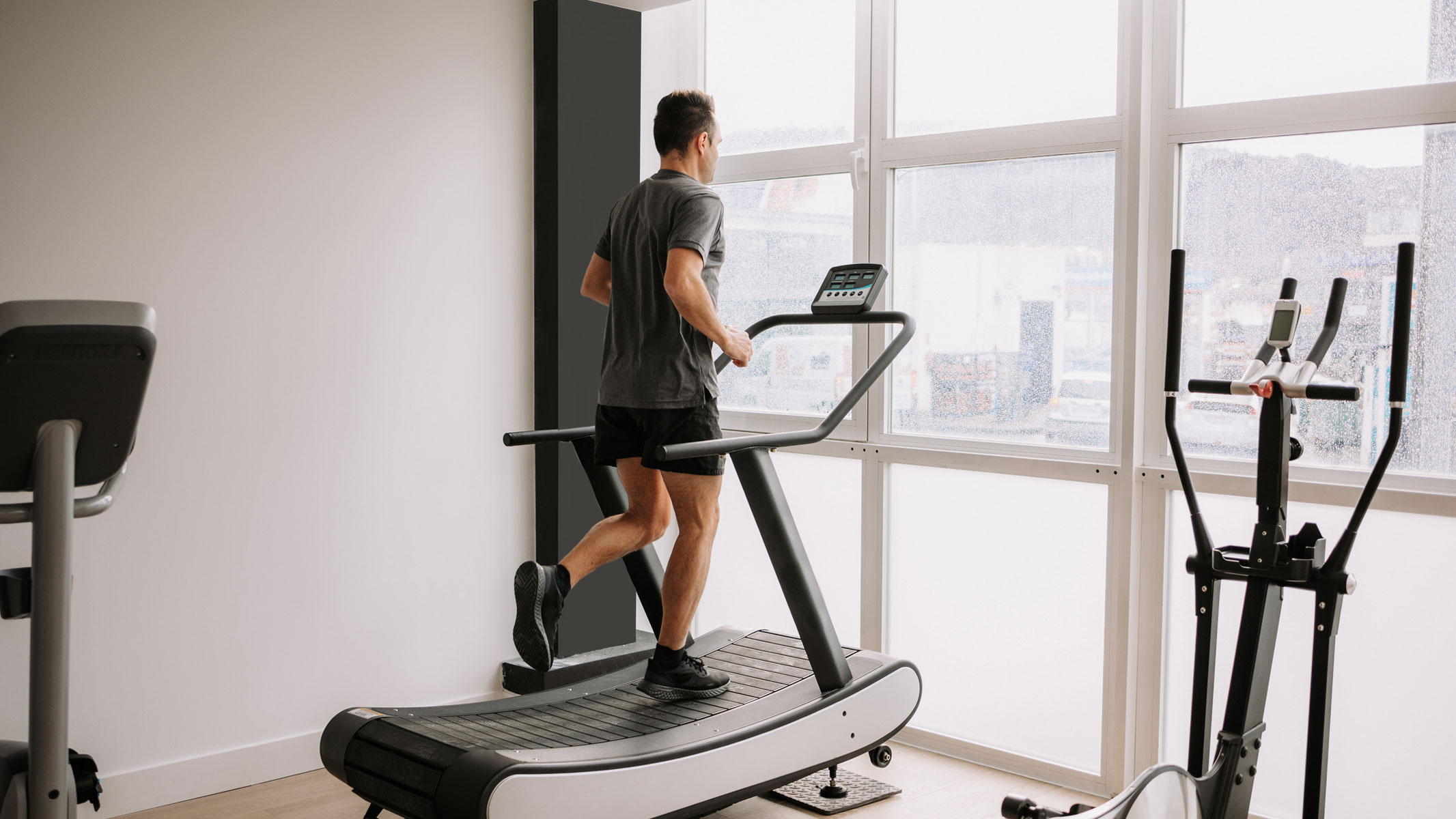 A picture of a man exercising on a treadmill at home