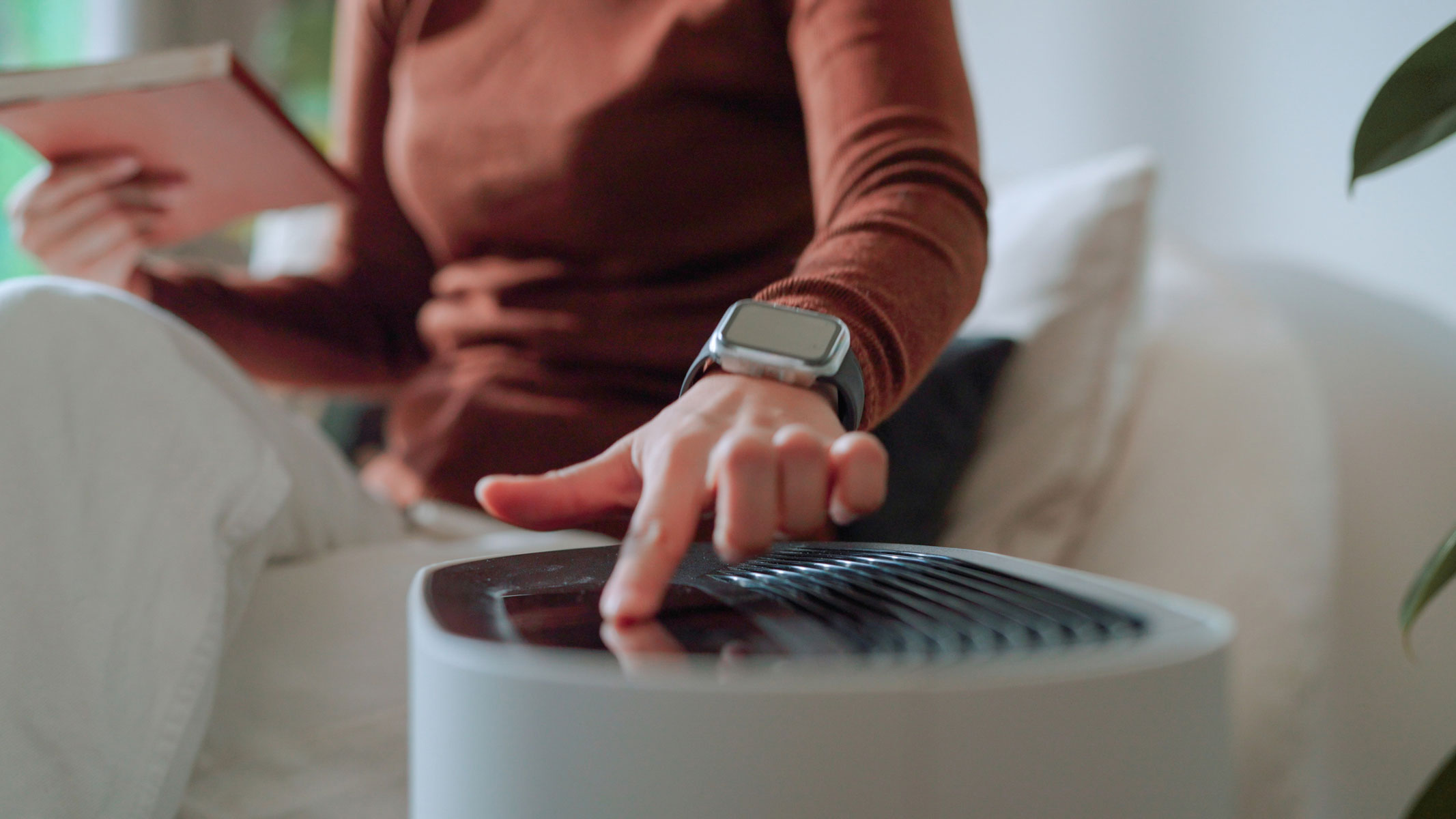 Close-up image of a woman replacing an air filter