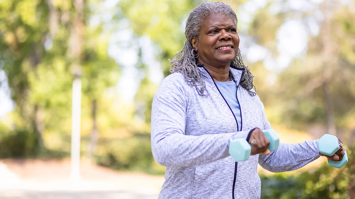 senior black women work out to stay healthy outdoors.