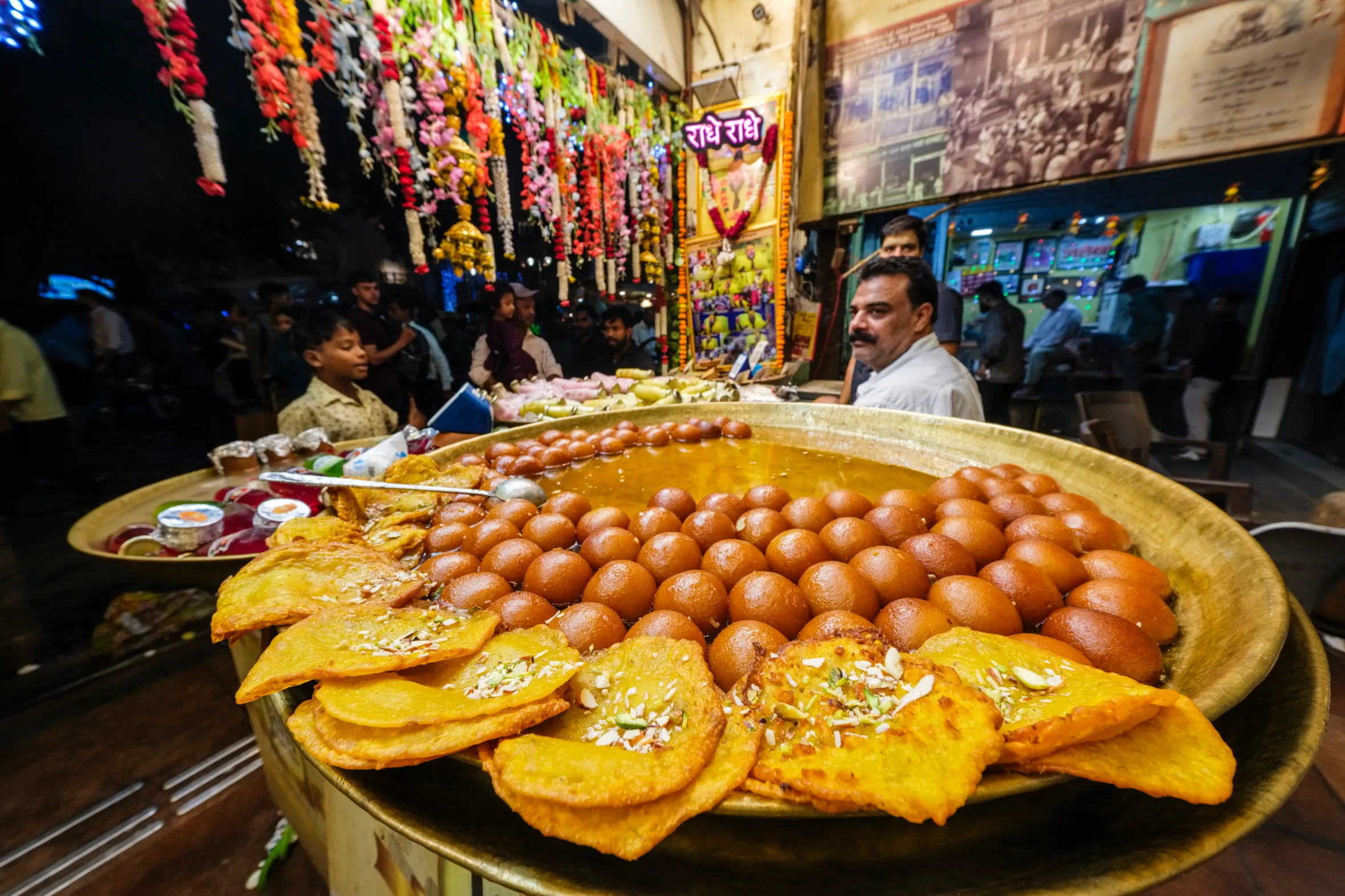 Street stalls in Old Delhi display trays of Gulab Jamun and other traditional sweets.