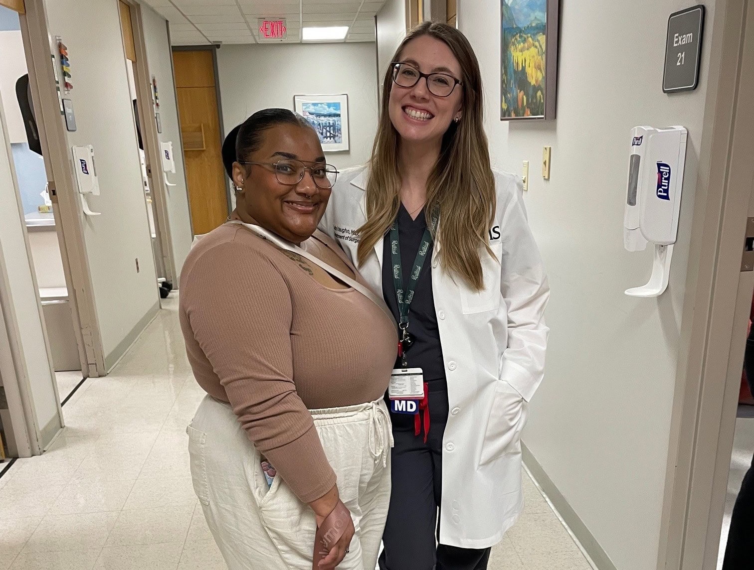 Jazmin Johnson, a patient, and her doctor, surgeon Lexie Vaughn, take a picture together in the hallway at UAMS.
