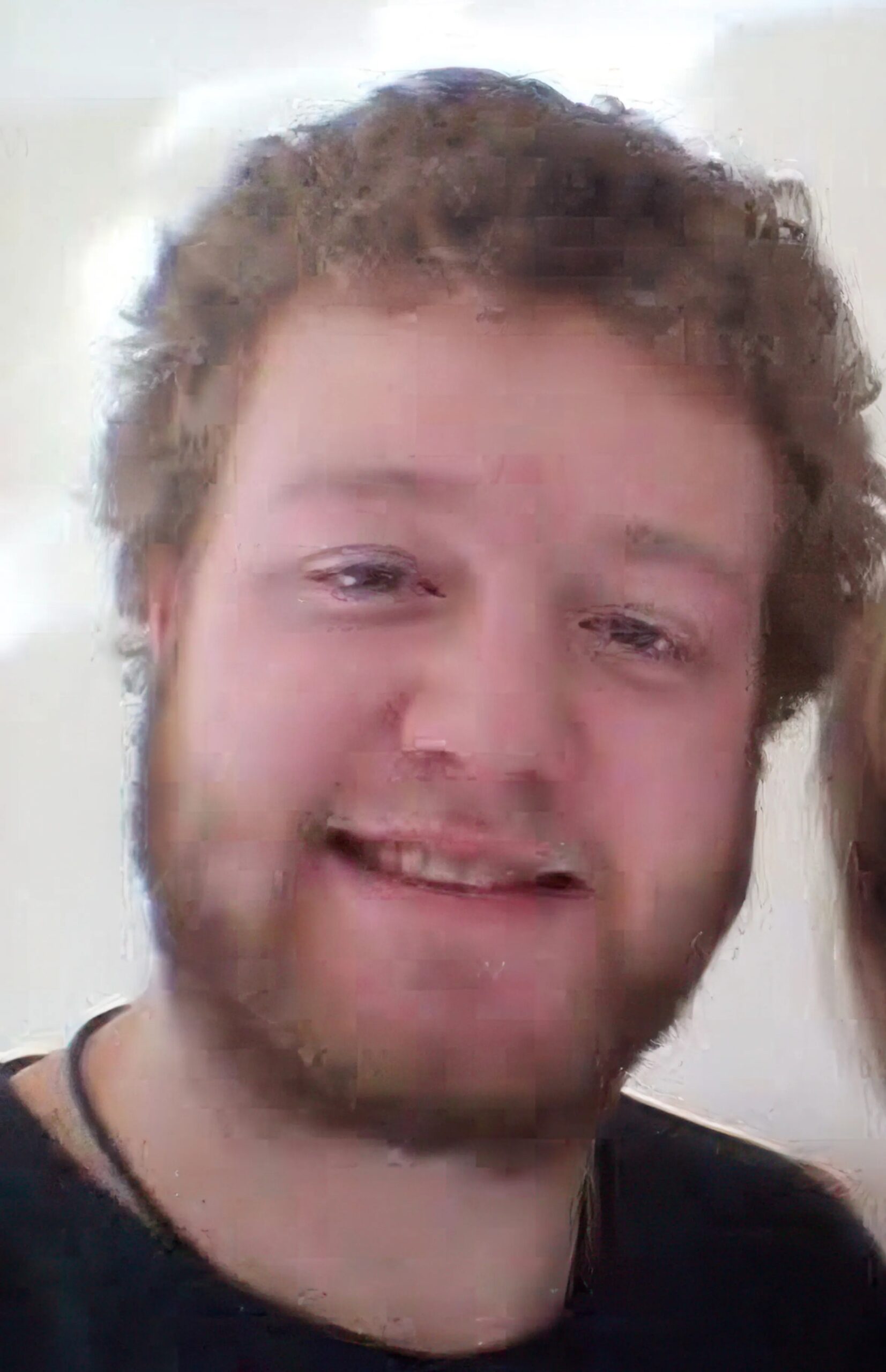 Christopher Monro, who killed his father Peter Monro, smiles at the camera.