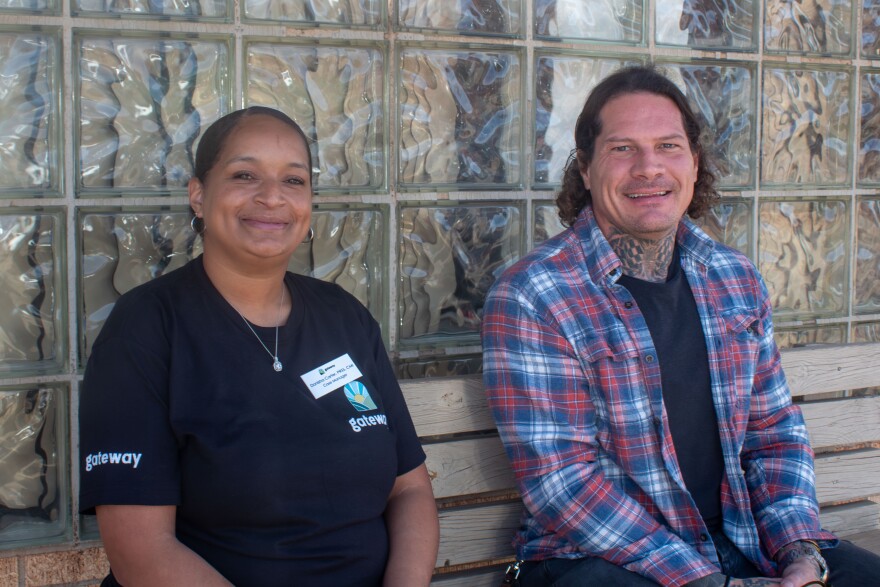 Josh Maxey (right) and his co-worker Donisha Carter (left) smile for a photo outside the Gateway office in Chandler.