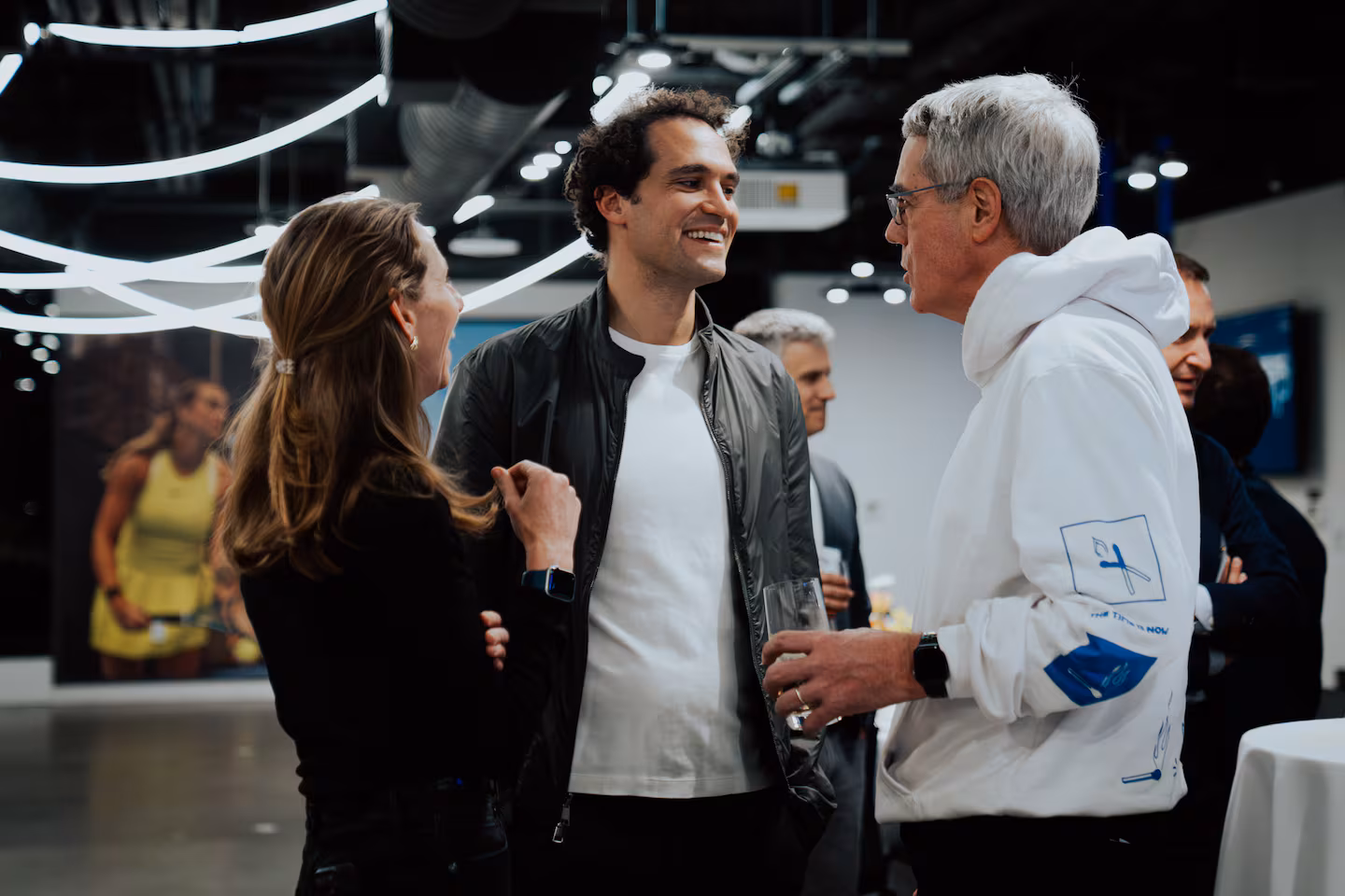 Whoop chief executive Will Ahmed (center) recently hosted local tech executives at his firm's Fenway headquarters to discuss how to encourage more startups working on AI applications to come to Boston.