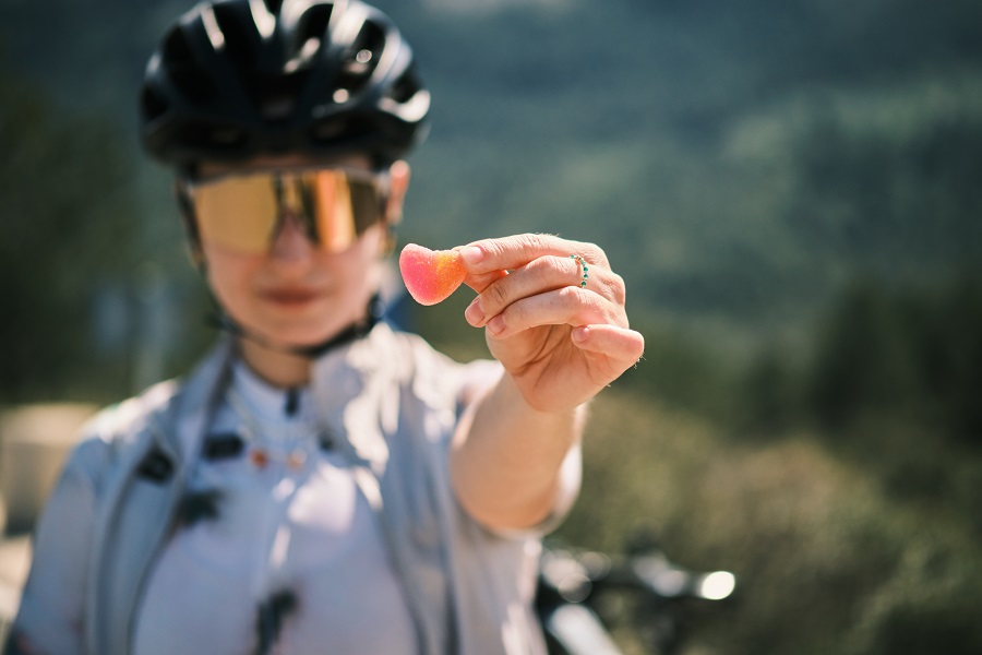 Female cyclist eats gummy supplements