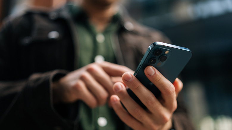 Man holding iPhone in hand