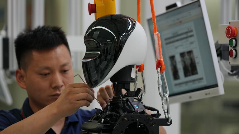 Workers assemble LY iTech Beijing Super Factory robots for artificial intelligence.