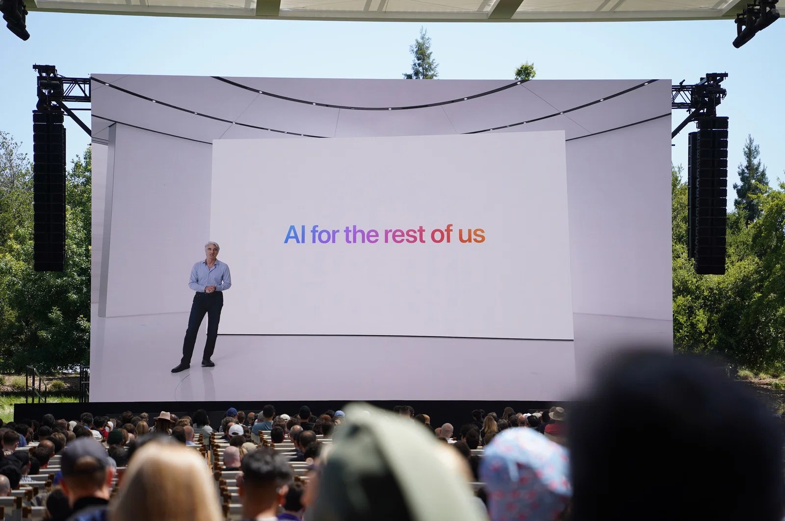 A photo of the 2024 WWDC keynote with the tagline “AI for the rest of us”.